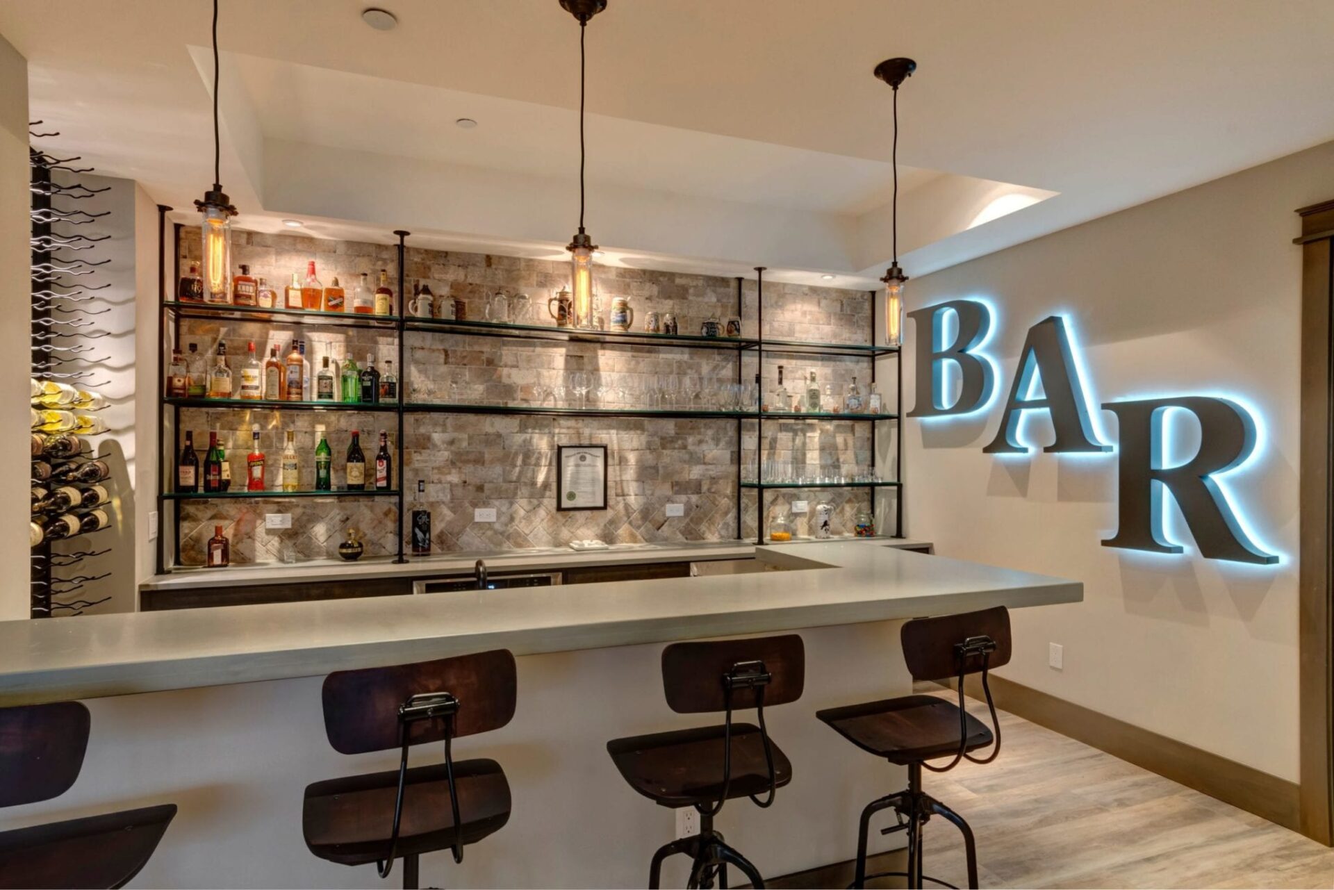 basement remodel wet bar | neon bar sign | open shelving liquor display