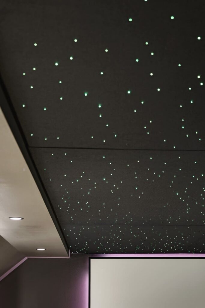 Star ceiling detail in custom home theater with recessed lighting and projector screen