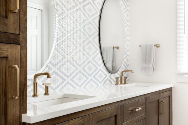 Double vanity with circular mirrors and patterned backsplash
