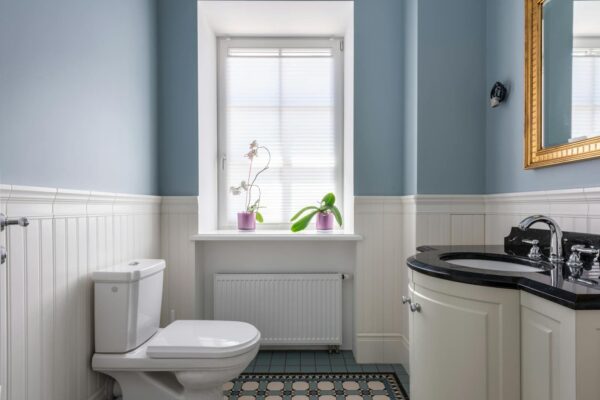 A small bathroom with natural light coming from the window.