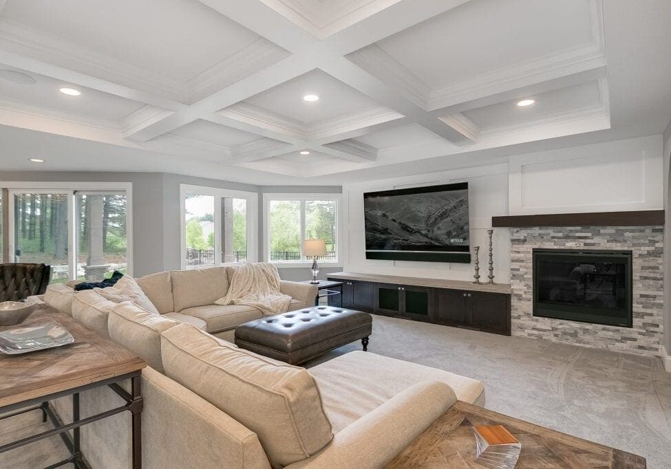 basement remodel with home theater and stone fireplace wall