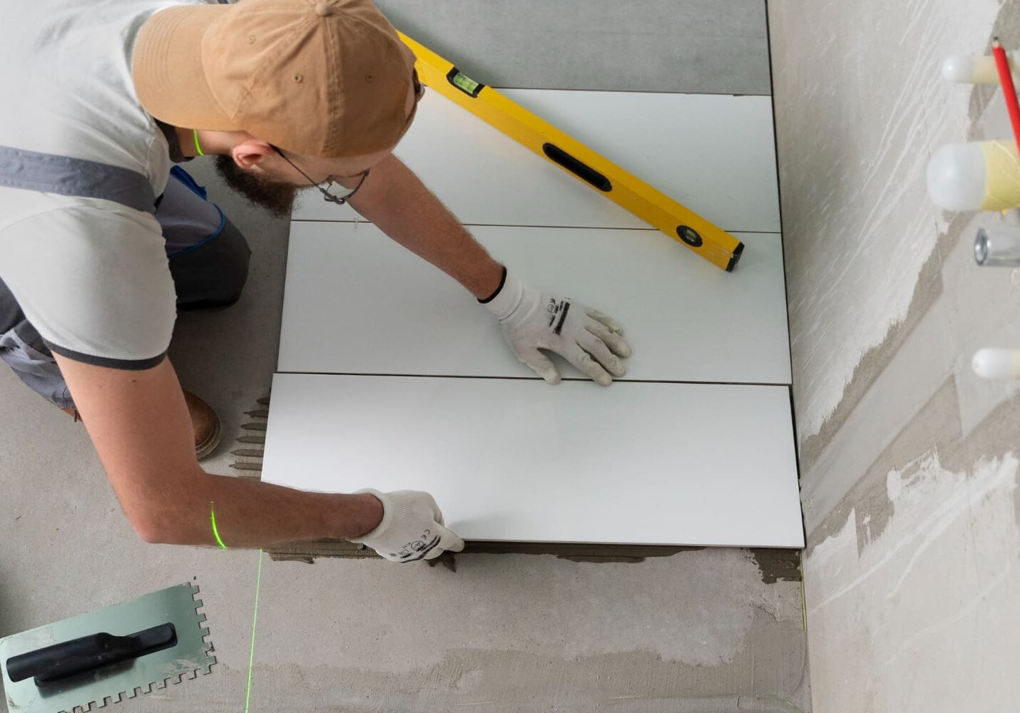 A contractor installing tiles for small bathroom ideas